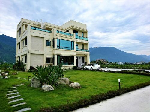 a house with a car parked in front of it at 1969 Meters Square Seed B&B in Jian
