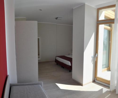 a bedroom with a bed and a window at Tullio Hotel in Gravedona