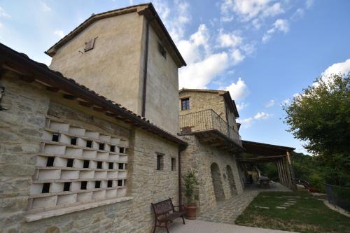 a building with a tower on the side of it at Talacchio in Città di Castello