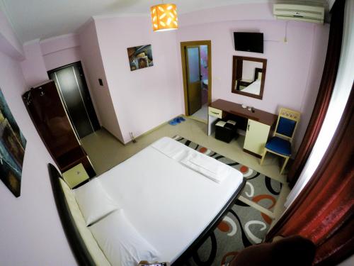 a hospital room with a bed and a desk at Hotel Freskia in Gjirokastër
