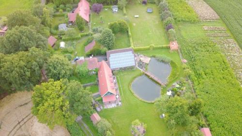 an aerial view of a farm with a house and two ponds at Urlaubsdomizil im Grünen in Westerstede
