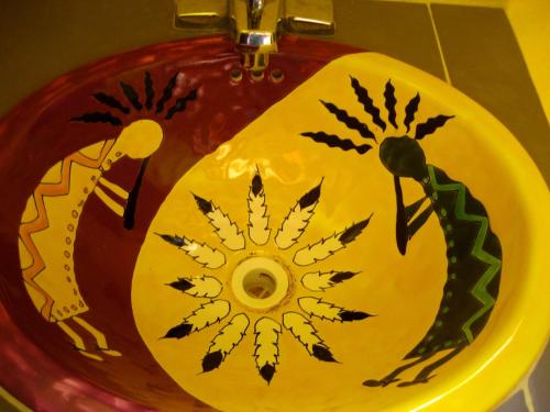 a sink with a yellow and blue bowl on top of it at Tribu Hostel in Holbox Island
