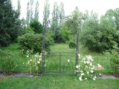 an iron gate in a field of flowers at Urlaubsdomizil im Grünen in Westerstede
