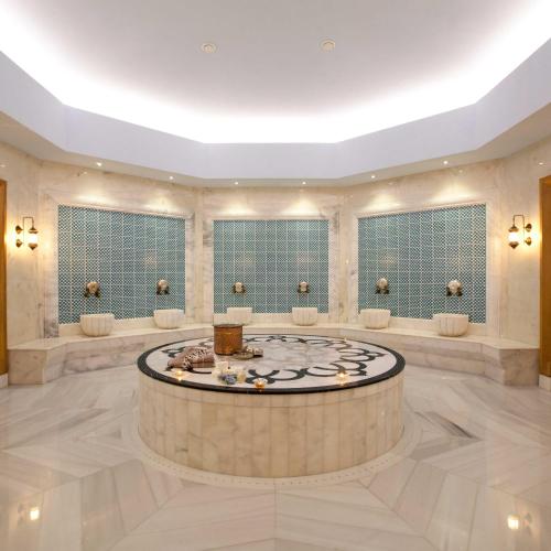 a large lobby with a round table in the middle at Paloma Oceana in Side