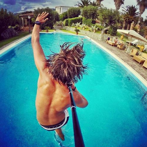 a shirtless man jumping into a swimming pool at Villa Amalia Srls in Gizzeria