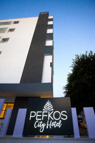 a city hotel sign in front of a building at Pefkos City Hotel in Limassol