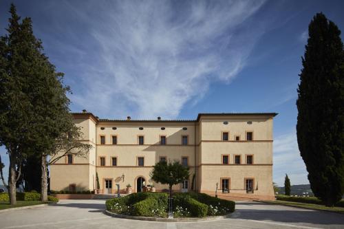 a large building with trees in front of it at Castello di Casole, A Belmond Hotel, Tuscany in Casole dʼElsa