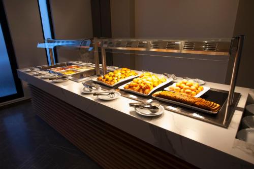 a buffet line with many different types of food at Pefkos City Hotel in Limassol