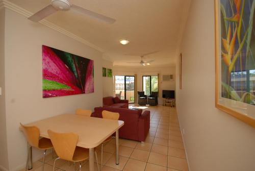 a living room with a table and a couch at City Plaza Apartments in Cairns