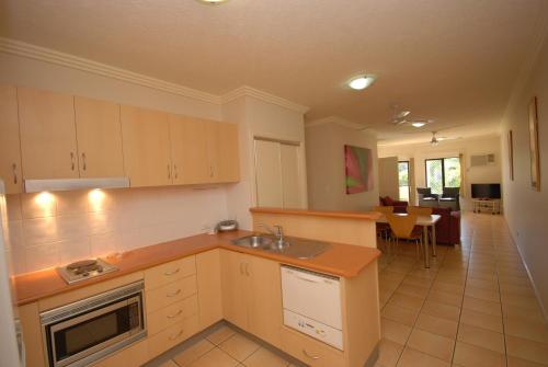 a kitchen with a sink and a counter top at City Plaza Apartments in Cairns