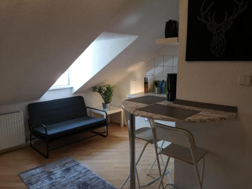 a living room with a couch and a table in a room at Sankt-Nikolaus Studio Innsbruck in Innsbruck