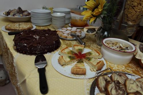 a table topped with a chocolate cake and bread at Garni Miravalle in Moena