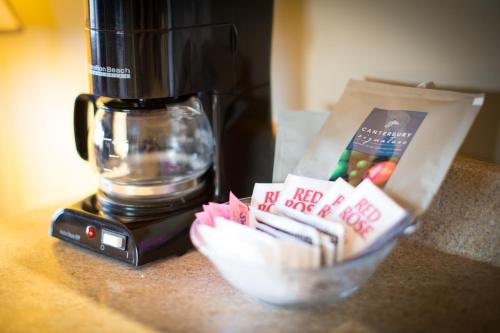 a coffee maker sitting on a counter with a bowl of food at Sidney Waterfront Inn & Suites in Sidney