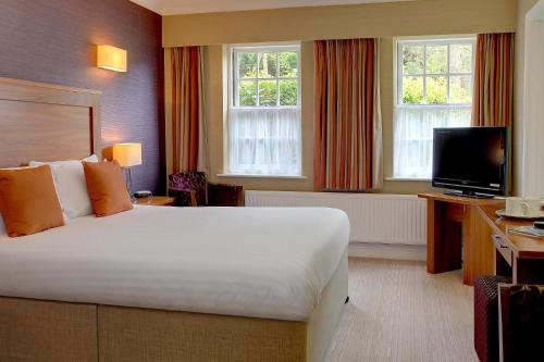a hotel room with a bed and a television at Best Western Moore Place Hotel in Milton Keynes