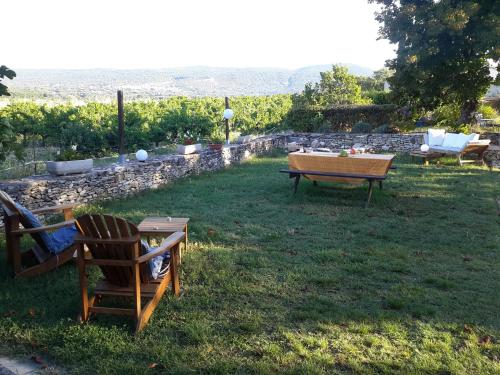 a picnic table and chairs in the grass in a yard at Les Granges in Villars