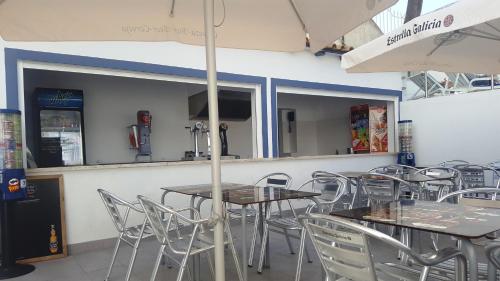 a row of tables and chairs in a restaurant at Apartamentos Turisticos Soldoiro in Albufeira