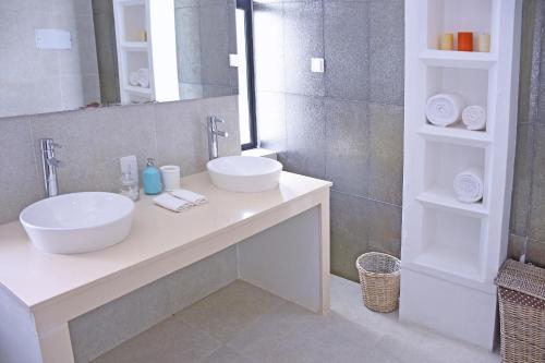 a bathroom with two sinks and a mirror at Villa Santé by The Serendipity Collection in Kalpitiya