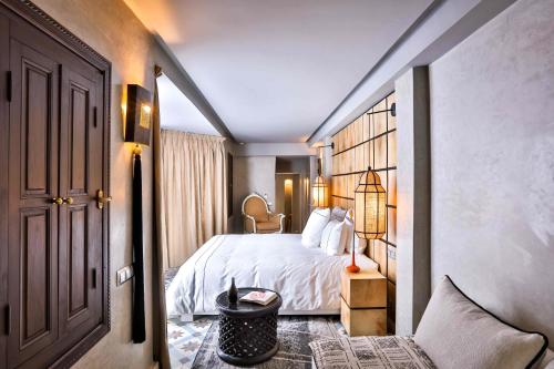 a hotel room with a bed and a hallway at Dar Kandi in Marrakech