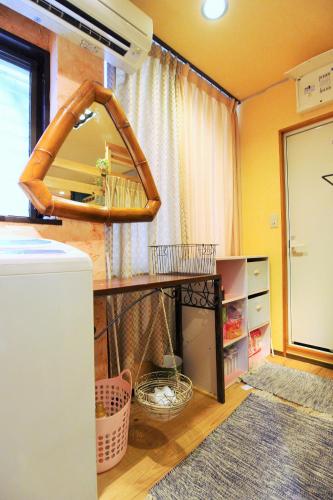 a room with a table with a mirror and a shelf at Koi Koi in Takamatsu