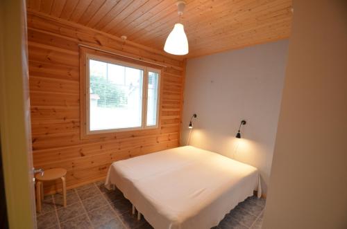 a bedroom with a white bed and a window at Apartment A3 Talja in Rovaniemi