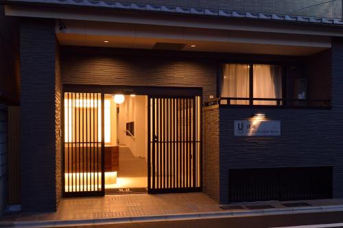 a front door of a building with a gate at UU Inn Kyoto in Kyoto