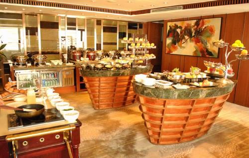 a buffet in a restaurant with food on display at Marco Polo Parkside, Beijing in Beijing