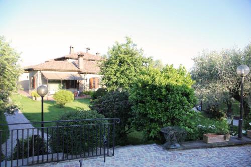 a house with a fence in front of a yard at B&B LE BACETTE in Caprarola