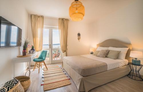 a bedroom with a large bed and a balcony at Villa Astra in Brela