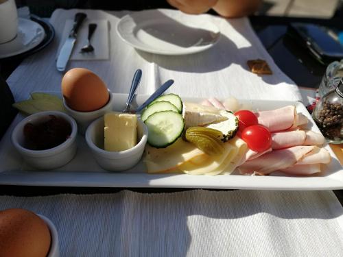a plate of food with meat vegetables and eggs on a table at Ferienwohnung Pichlarn in Aigen im Ennstal