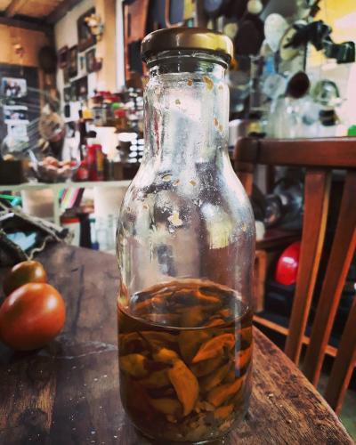 a glass jar filled with food on top of a table at Jacamaki Nature GuestHouse en Villa de Leyva in Villa de Leyva