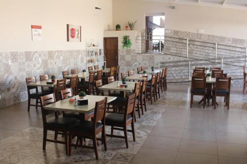 a dining room with wooden tables and chairs at Pousada Do Mineiro in Olímpia