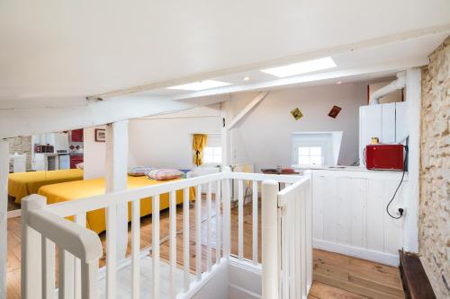 a room with a staircase leading up to a bedroom at Petit studio Saint-Front- Small studio flat Saint-Front in Périgueux
