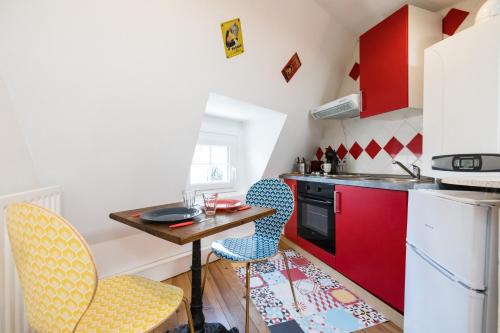 a small kitchen with a small table and chairs at Petit studio Saint-Front- Small studio flat Saint-Front in Périgueux