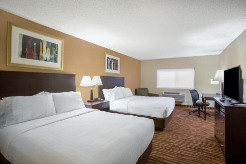 a hotel room with two beds and a television at First Choice Inn at the Swell in Green River