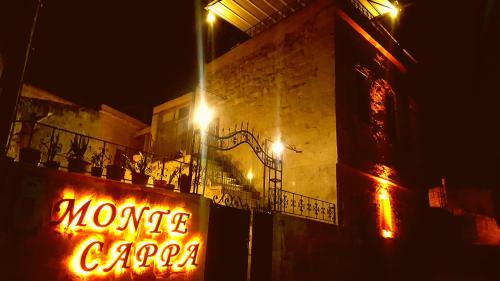a neon sign that says money cargo on the side of a building at Monte Cappa Cave House in Urgup