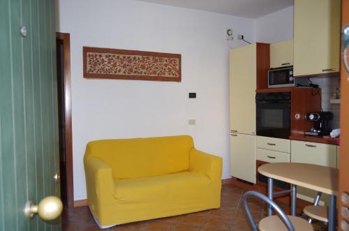 una silla amarilla en una cocina con mesa en Residenza Ducale, en Ferrara
