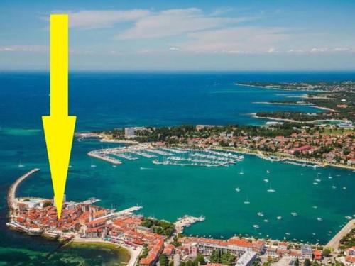 an aerial view of a harbor with a yellow arrow at Studio apartman Mima in Umag