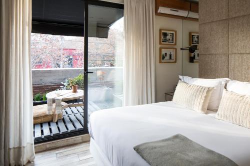a bedroom with a bed and a large window at Maison Italia 1029 in Santiago