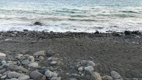 a group of rocks on a beach near the water at Sofia Apartment in Léntas