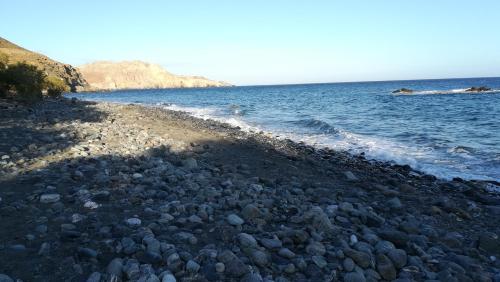 a large group of rocks on the shore of the ocean at Sofia Apartment in Léntas