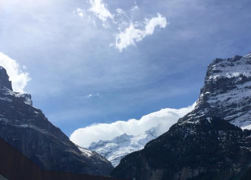 a view of a mountain range with snow covered mountains at Amazing Apartment EIGER Grindelwald in Grindelwald