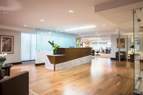 an office with a reception desk and a lobby at Barcelo Guadalajara in Guadalajara
