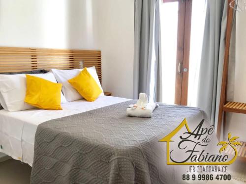 a bed with a stuffed animal sitting on top of it at Apê do Fabiano in Jericoacoara