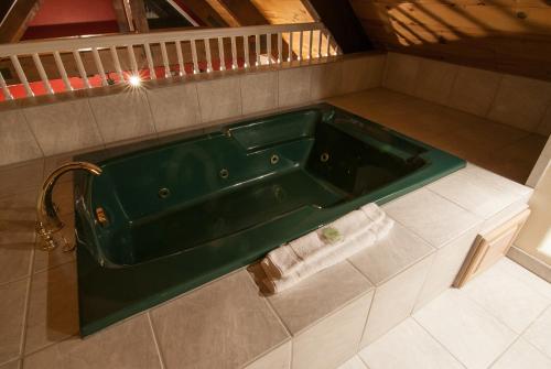 a green bath tub in a bathroom with a towel at North Lake Lodges & Villas in Incline Village