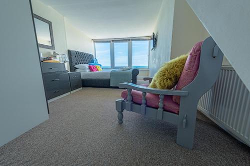 a baby room with a chair and a bed at Villa Mentone Hotel in Shanklin