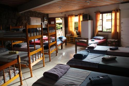 a room with several bunk beds in a room at Joaquina 433 - Pousada Floripa in Florianópolis