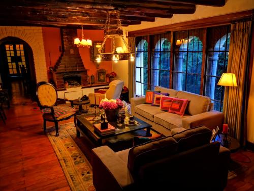 a living room filled with furniture and a fireplace at Inka Tambo Hacienda in Cusco