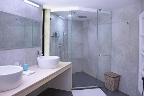 a bathroom with a sink and a shower at Villa Santé by The Serendipity Collection in Kalpitiya
