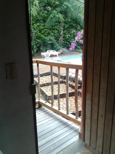 an open door to a deck with a swimming pool at Selvablanca Hostel in San Jerónimo