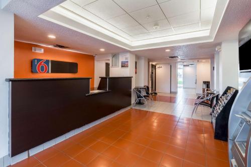 a lobby of a hospital with a bar and chairs at Motel 6-Irving, TX - DFW Airport North in Irving